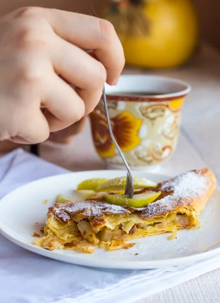 Eat apple strudel on a white plate, hands, — Stock Photo, Image