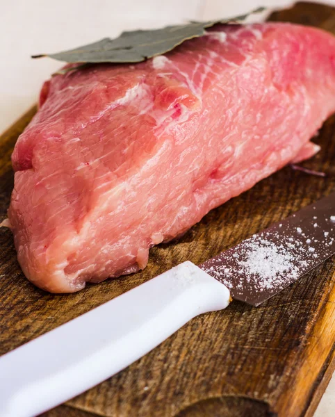 Raw meat on a cutting board with spices, knife — Stock Photo, Image