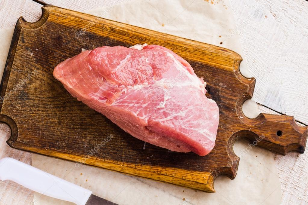 piece of pork on a cutting board