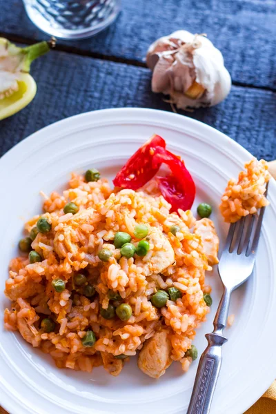Risotto with chicken and vegetables on a plate with fork — Stock Photo, Image