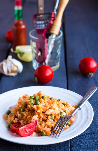 Risotto with chicken and vegetables on dark wooden board — Stock Photo, Image