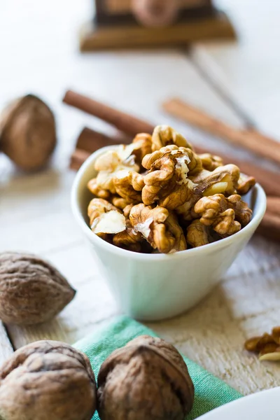 Raw walnuts in a white bowl, white background — Stock Photo, Image