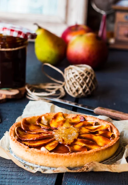 round apple tart with pear jam and caramel, vertically