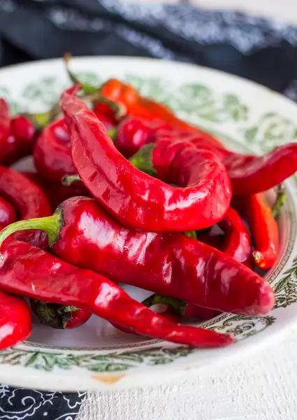 Fresh chili pepper in a plate on a board — Stock Photo, Image