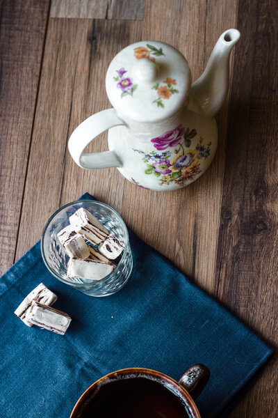nougat candy in a glass and tea, blue napkin