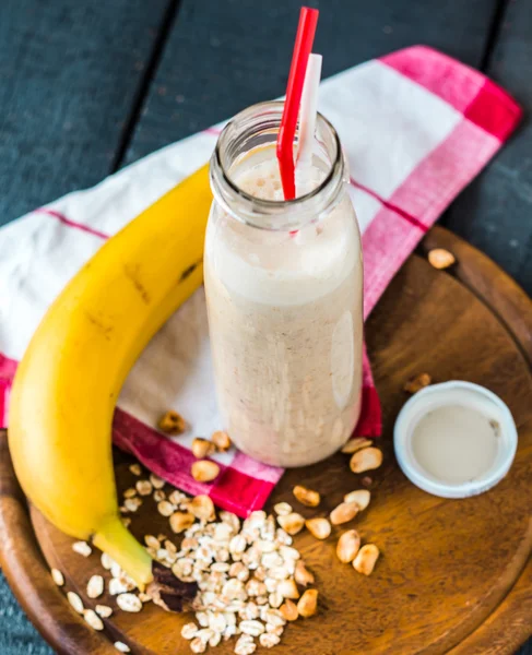 banana smoothie with oat flakes and milk in the bottle