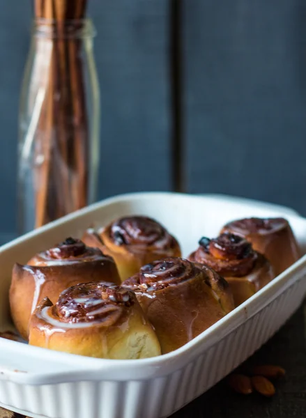 Cinnabon cinnamon rolls and sauce in white baking dish — Stock Photo, Image