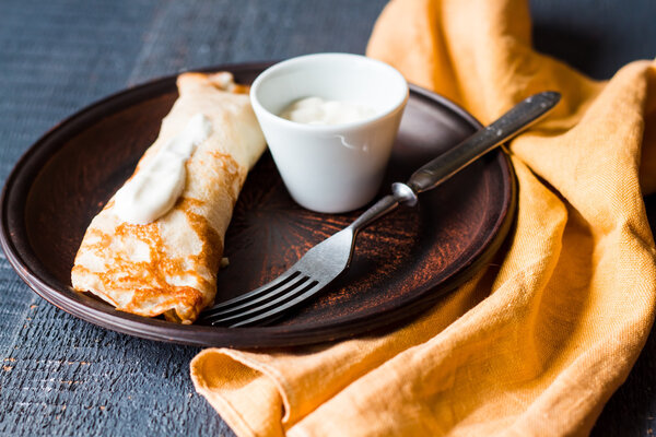 thin pancakes stuffed with sour cream, Slavic cuisine, fork