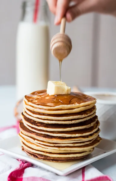 Pile of Pancake with butter, honey sauce add,  hands — Stock Photo, Image