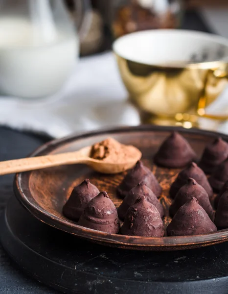 Truffle chocolates with a cup of coffee and cream — Stock Photo, Image