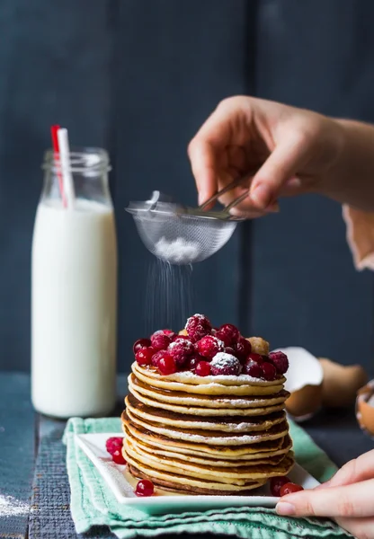 Pfannkuchen mit Preiselbeeren und Himbeeren bestreut mit Pulver — Stockfoto