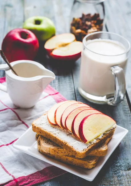 toast with curd cheese and sweet red apple, a cup of milk