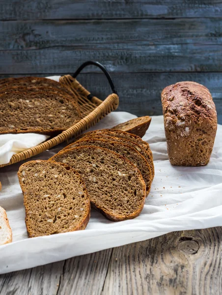 Fresh rye bread on a white linen tableclothl, rustic — Stock Photo, Image