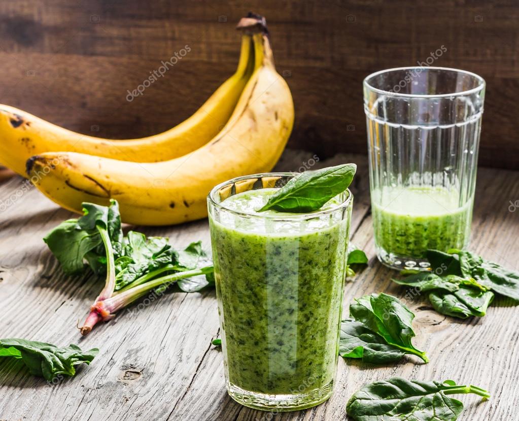 Green smoothie with spinach, banana and peanut milk Stock Photo by