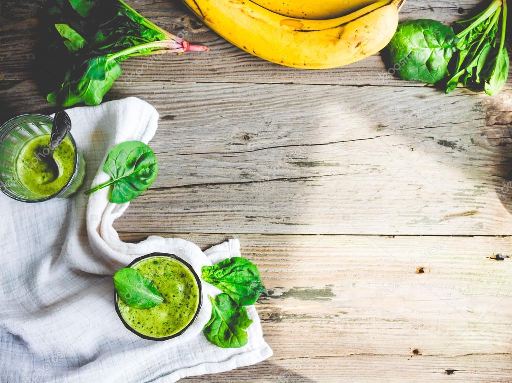 Vitamin green smoothie with spinach leaves, banana and peanut mi