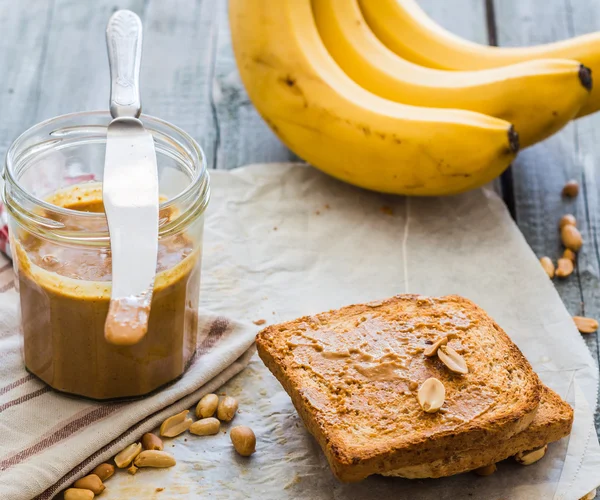 Krispig toast med jordnötssmör, bananer, frukost — Stockfoto