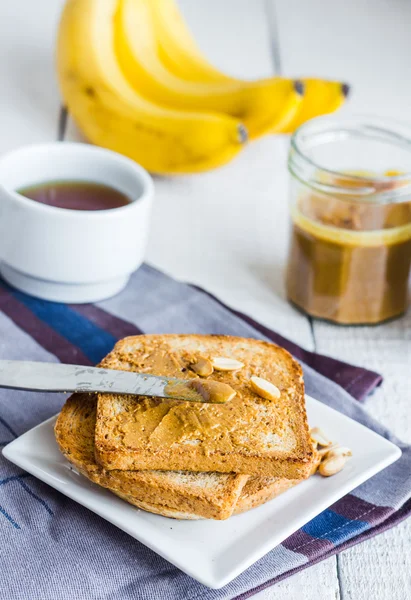 crispy toast with peanut butter, bananas, coffee, breakfast