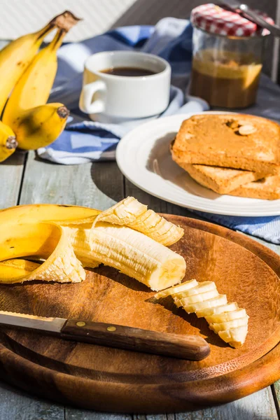 Cut with a knife into pieces of fresh, ripe banana — Stock Photo, Image