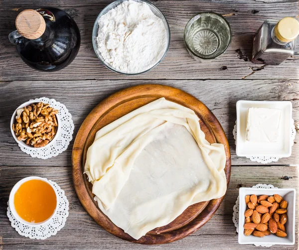 Ingredients for making homemade baklava,phyllo dough, nuts, hone