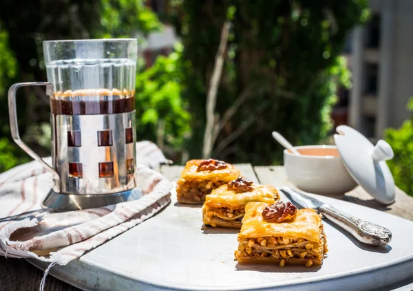 Pieces of sweet baklava, garden background, selective focus — Stock Photo, Image