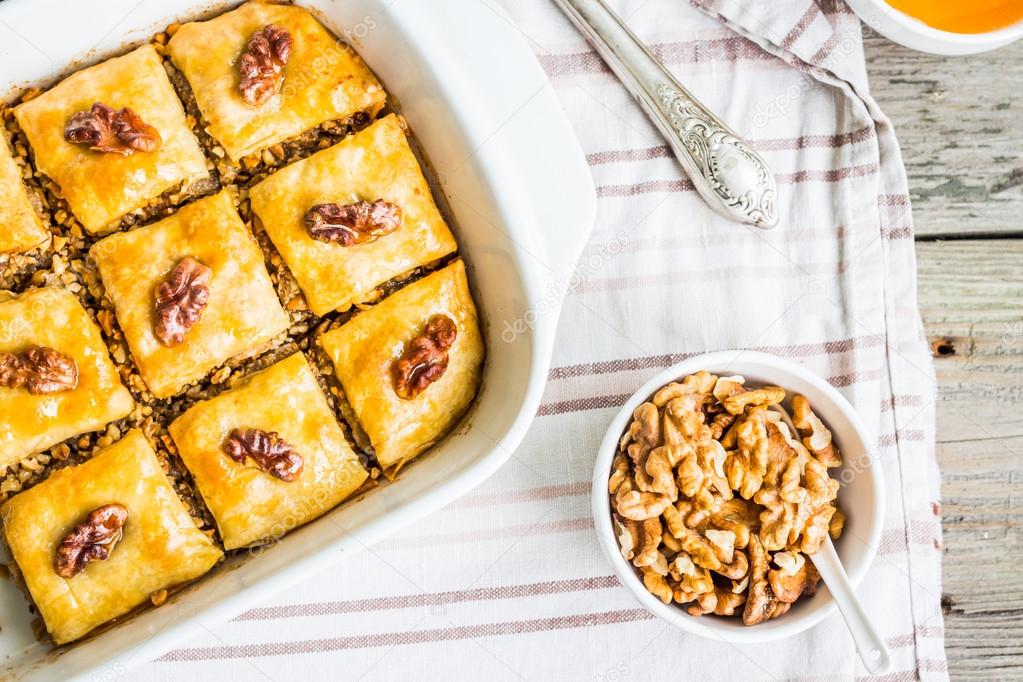 pieces of baklava with honey and nuts, top view, rustic