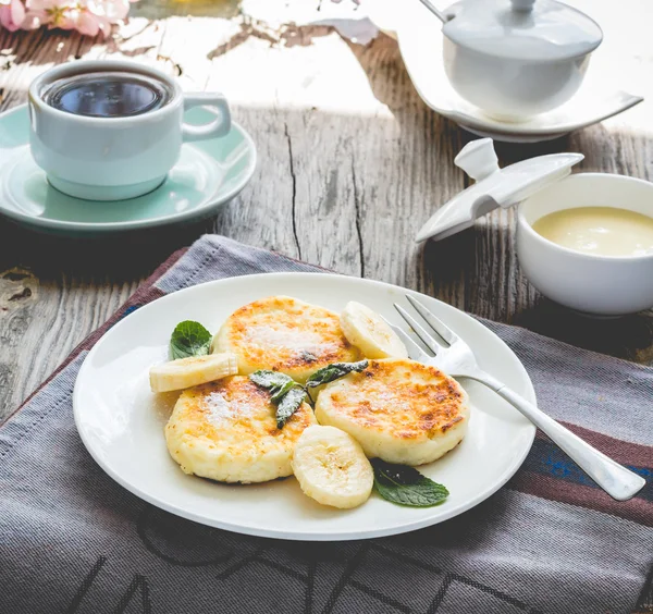 Panquecas de queijo cottage com banana, açúcar em pó e mi — Fotografia de Stock