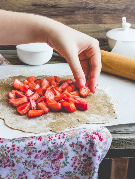 cooking processes biscuit with fresh strawberries, vegan dessert