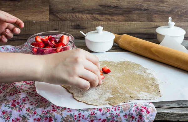 cooking processes rye biscuit with fresh strawberries, healthy d