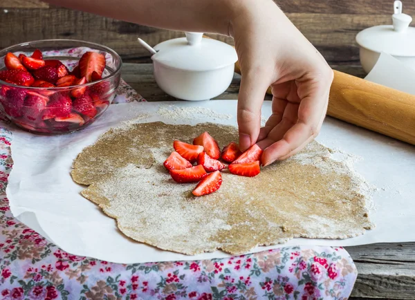 cooking processes rye biscuit with fresh strawberries, healthy v