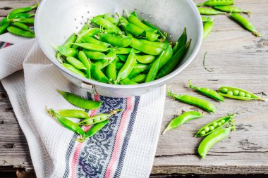 ham yeşil bezelye, bakla Genç, metal bir kevgir, rustik