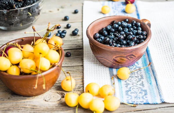 Frische Blaubeeren, Kirschen und Maulbeeren auf einem grauen Holzrücken — Stockfoto