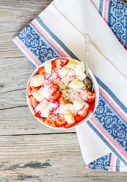 oatmeal with poppy seeds, raisins, strawberries and banana