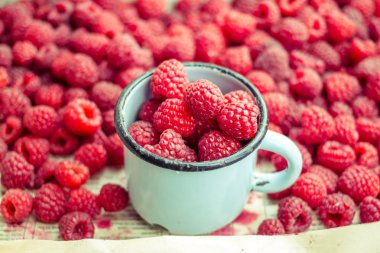 bir metal kupa ve plaser taze kırmızı ahududu