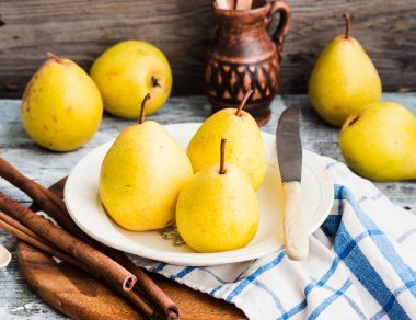 Ahşap bir masa, tarçın, Natürmort üzerinde taze sarı armut