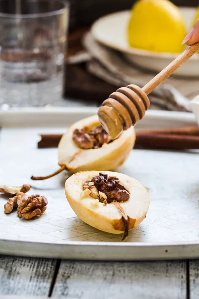 Spicy baked pear with walnuts, honey, cinnamon sticks, healthy d — Stock Photo, Image