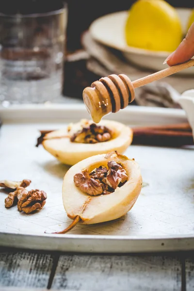 Spicy baked pear with walnuts, honey, healthy dessert, rustic,ti — Stock Photo, Image