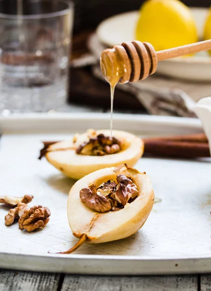 Spicy baked pear with walnuts, honey, cinnamon sticks, healthy d — Stock Photo, Image