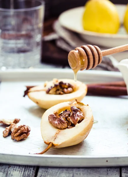 Spicy baked pear with walnuts, honey, cinnamon sticks, healthy d — Stock Photo, Image