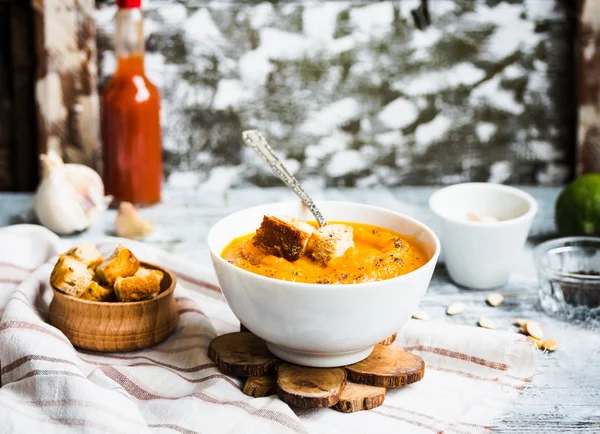 Pumpkin soup with carrots, croutons in a white dish, vegetarian — Stock Photo, Image