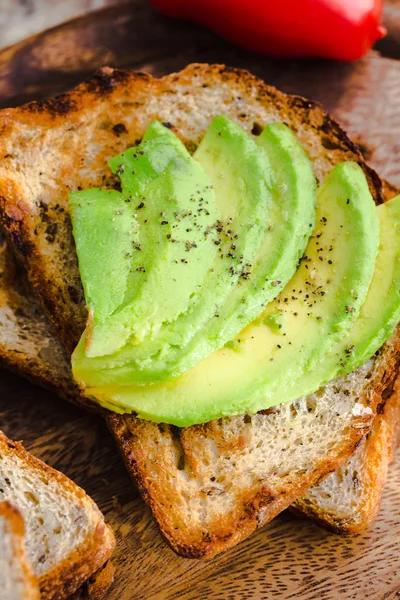 Toast with fresh avocado and pepper, healthy snack, closeup — Stock Photo, Image