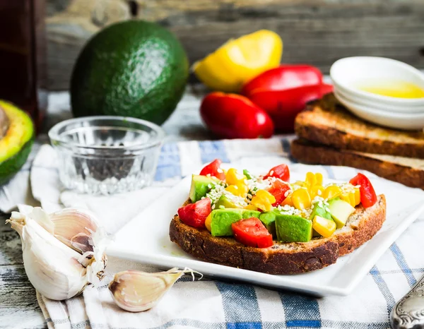 Toast with fresh avocado, tomato and corn — Stock Photo, Image