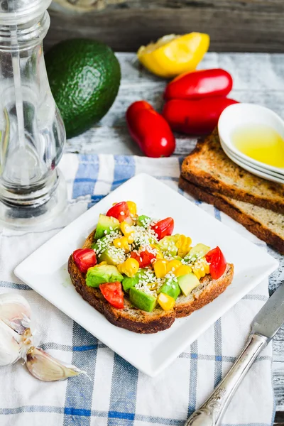 Toast with fresh avocado, tomato and corn — Stock Photo, Image