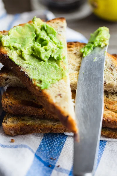 Avocado plakken op volkoren toast, Ontbijt — Stockfoto