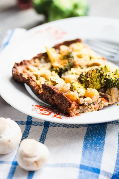 vegan pizza pie with broccoli, mushrooms and chickpeas dough wit