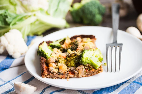 vegan pizza pie with broccoli, mushrooms and chickpeas dough wit