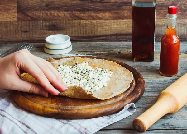 Ржаное печенье с козьим сыром и травами, процесс приготовления, рука — стоковое фото