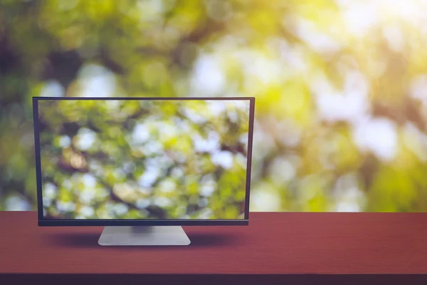 The computer on table and background nature