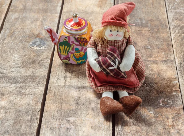 Rag dolls and tea on a wooden table