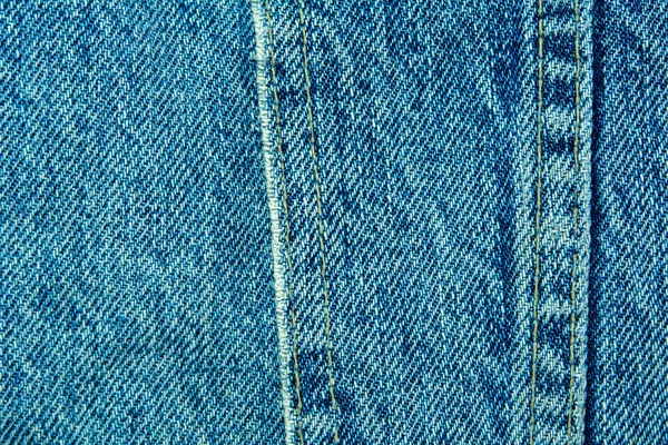 Blue denim fabric with seam — Stock Photo, Image