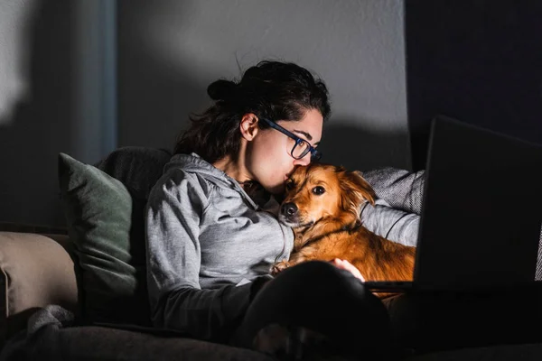Young Woman Kisses Her Dog While Watching Movie Her Computer — Stock Photo, Image